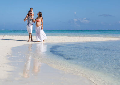 photo de maternité d'un couple et leur enfant au bord de l'eau